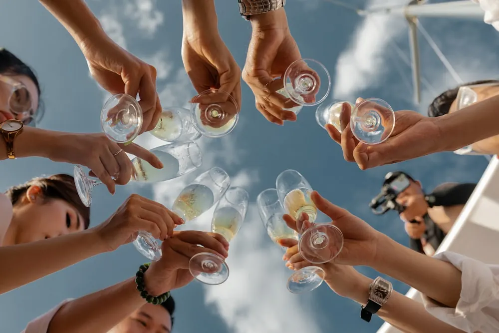 NOOZ launch activation, hands toasting cans